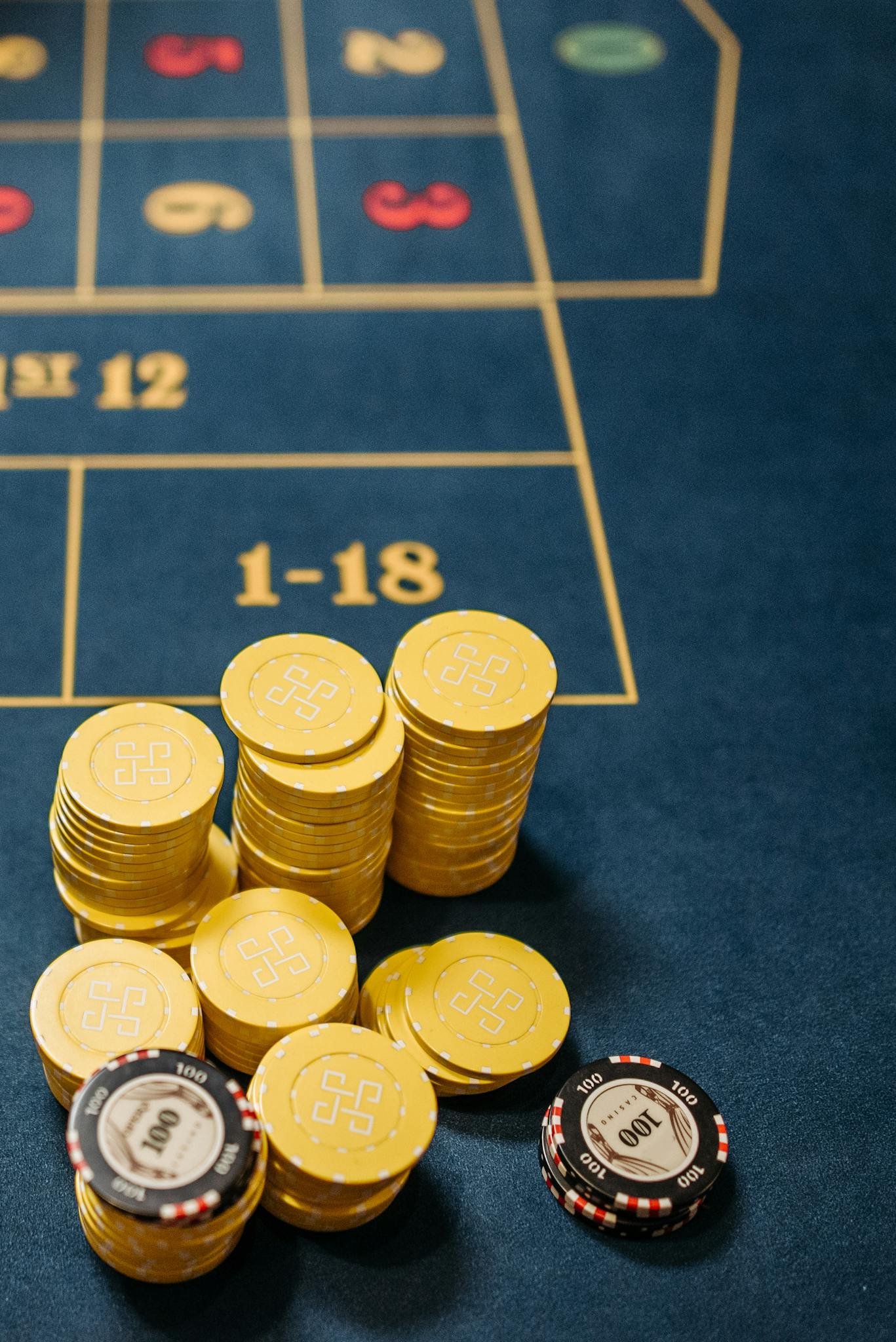 About Gambling chips stacked on a roulette table, emphasizing chance and luck in gaming.